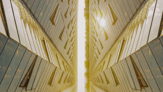 a mirrored image of futuristic building glass facade exterior